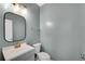 Well-lit half bathroom with a modern vanity, sleek mirror, and fresh paint at 5835 Sterling Ct, Cumming, GA 30040