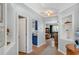 Bright hallway with hardwood floors, built-in shelving, and an inviting view into the living room at 5835 Sterling Ct, Cumming, GA 30040