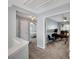 A bright hallway leads to a home office space, featuring a modern desk, chair, and ample natural light at 5835 Sterling Ct, Cumming, GA 30040