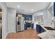 Modern kitchen featuring blue cabinetry, stainless steel appliances, and granite countertops at 5835 Sterling Ct, Cumming, GA 30040