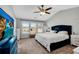 A spacious main bedroom with vaulted ceilings, a ceiling fan, and large windows offering plenty of natural light at 5835 Sterling Ct, Cumming, GA 30040