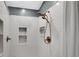 Shower featuring white tiled walls, two built-in niches, and brass shower head with two sprayers at 5835 Sterling Ct, Cumming, GA 30040