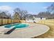 Backyard swimming pool with diving board and concrete patio surrounded by a wooden fence and the exterior of the home at 36 S Forty E Pass, Hiram, GA 30141