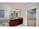 Main bathroom featuring double sinks, granite countertops, and a large framed mirror at 4192 Pelham Cir, Lithonia, GA 30038