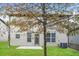 This backyard features lush green grass, a small patio, and a large tree in the center at 4924 Rapahoe Trl, Atlanta, GA 30349