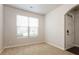 This bedroom features neutral walls, carpet floors, and a window bringing in natural light at 4924 Rapahoe Trl, Atlanta, GA 30349