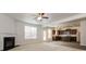 Open-concept living space with fireplace flows into modern kitchen featuring stainless steel appliances at 4924 Rapahoe Trl, Atlanta, GA 30349