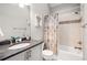 Bathroom featuring granite countertops, tub with shower, and modern fixtures at 1255 Wildcliff Ne Pkwy, Atlanta, GA 30329
