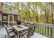 Open deck showcases an outdoor dining set and peaceful wooded views for relaxing and entertaining at 1255 Wildcliff Ne Pkwy, Atlanta, GA 30329