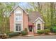 Charming brick home with manicured landscaping, and a red awning over the front door at 1255 Wildcliff Ne Pkwy, Atlanta, GA 30329