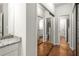Bright hallway featuring hardwood floors and mirrored closet doors at 1255 Wildcliff Ne Pkwy, Atlanta, GA 30329