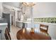 Open kitchen with light wood floors, stainless steel appliances, stone countertops, and a dining table at 1255 Wildcliff Ne Pkwy, Atlanta, GA 30329