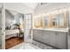 Bright bathroom featuring double vanity with stone countertop and access to main bedroom at 1255 Wildcliff Ne Pkwy, Atlanta, GA 30329