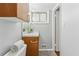 Bright bathroom featuring a white sink, gray walls, wood-tone cabinets, and tiled floors at 3048 Briarcliff Ne Rd # 2, Atlanta, GA 30329