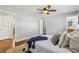 Bright bedroom featuring hardwood floors, ensuite bath, ceiling fan, and cozy decor at 3048 Briarcliff Ne Rd # 2, Atlanta, GA 30329