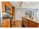 Well-lit kitchen with granite countertops, wooden cabinets, and stainless steel appliances at 3048 Briarcliff Ne Rd # 2, Atlanta, GA 30329