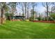 View of a large, lush backyard with a well-maintained lawn and surrounding mature trees at 3637 Eaglerock Dr, Atlanta, GA 30340