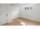 Finished basement room with a window, light hardwood flooring and white painted walls and trim at 3637 Eaglerock Dr, Atlanta, GA 30340