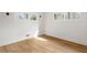 Bright bedroom with hardwood floors, white walls, and two windows, offering a clean and modern aesthetic at 3637 Eaglerock Dr, Atlanta, GA 30340