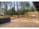 Spacious wooden deck with a built-in outdoor kitchen featuring a grill and ample counter space at 3637 Eaglerock Dr, Atlanta, GA 30340