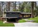Contemporary exterior with dark siding, carport, stone walkway, and natural landscaping at 3637 Eaglerock Dr, Atlanta, GA 30340
