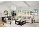 Bright living room with large windows, white sofa, and hardwood floors at 3637 Eaglerock Dr, Atlanta, GA 30340