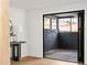 Covered patio with black brick accent wall and modern sliding glass doors at 3637 Eaglerock Dr, Atlanta, GA 30340