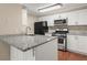 The kitchen has granite countertops, stainless steel appliances, and white cabinets at 1371 Keys Lake Ne Dr, Brookhaven, GA 30319