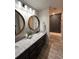 Bright bathroom featuring a large double vanity with granite countertops, wood framed mirrors and a shower at 1449 Albans Ct, Lithonia, GA 30058