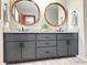 Bathroom features dual sink vanity with granite countertop and framed mirrors at 1449 Albans Ct, Lithonia, GA 30058
