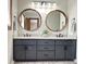 Bathroom features dual sink vanity with granite countertop and framed mirrors at 1449 Albans Ct, Lithonia, GA 30058