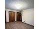 Spacious bedroom with wood-look floors and traditional wood closets at 1449 Albans Ct, Lithonia, GA 30058