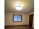 Spacious bedroom with wood-look flooring, window, and modern ceiling light at 1449 Albans Ct, Lithonia, GA 30058