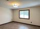 A bedroom featuring vinyl floors, a window, and neutral-colored walls at 1449 Albans Ct, Lithonia, GA 30058