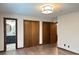 Bedroom featuring wood-look flooring, modern ceiling light, and bathroom access at 1449 Albans Ct, Lithonia, GA 30058