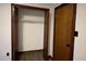 A bedroom featuring an empty closet with wooden double doors and vinyl floors at 1449 Albans Ct, Lithonia, GA 30058