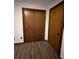 A bedroom featuring a closet with wooden double doors and vinyl floors at 1449 Albans Ct, Lithonia, GA 30058