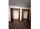 Open bedroom closets with wood trim and wood-look flooring at 1449 Albans Ct, Lithonia, GA 30058