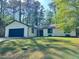 Inviting single-story home with a well-manicured lawn and a classic, neutral color scheme at 1449 Albans Ct, Lithonia, GA 30058