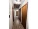 Hallway showing wood-look floors, white walls, and a textured ceiling at 1449 Albans Ct, Lithonia, GA 30058