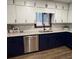 Renovated kitchen featuring granite countertops, white subway tile backsplash, stainless steel appliances, and refinished cabinets at 1449 Albans Ct, Lithonia, GA 30058