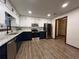 Spacious open kitchen with stainless steel appliances, granite countertops, two-tone cabinets, and modern finishes at 1449 Albans Ct, Lithonia, GA 30058