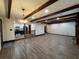 Spacious living room with hardwood floors, wooden ceiling beams, and fireplace adjacent to kitchen at 1449 Albans Ct, Lithonia, GA 30058