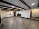 Spacious living room with hardwood floors, wooden ceiling beams and fireplace adjacent to kitchen at 1449 Albans Ct, Lithonia, GA 30058