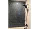 Vertical subway tile in dark grey contrasts against bright white walls in this bathroom shower at 1449 Albans Ct, Lithonia, GA 30058