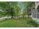 The backyard features mature trees, green lawn, and a fire pit with chairs at 1610 Elm Ne St, Conyers, GA 30012