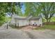 View of the rear exterior and yard featuring a patio and mature trees at 1610 Elm Ne St, Conyers, GA 30012