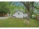 View of the home's backyard and gravel parking area at 1610 Elm Ne St, Conyers, GA 30012