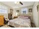Comfortable bedroom featuring a floral quilt and wood-look flooring at 1610 Elm Ne St, Conyers, GA 30012
