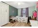 Bedroom featuring wood floors, a comfortable bed, and a double-door closet at 1610 Elm Ne St, Conyers, GA 30012